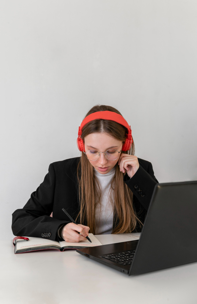 Transcriber listening to a recording and taking notes